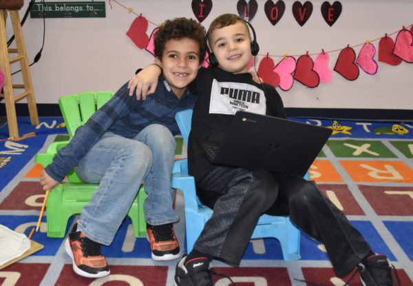 Two young students at Becker Elementary in Dearborn smile for the camera in February 2020.