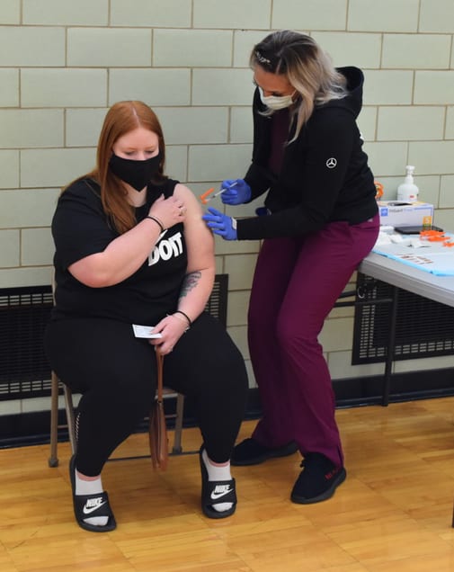 An Edsel Ford student gets a COVID vaccination during a clinic at the school on April 5, 2021.