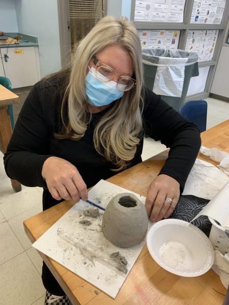 Dearborn Schools art teacher Sunshine Durant works on Tuesday, Nov. 2, on making a clay bowl like the ones that will be given away during the Empty Bowls fundraiser meal.