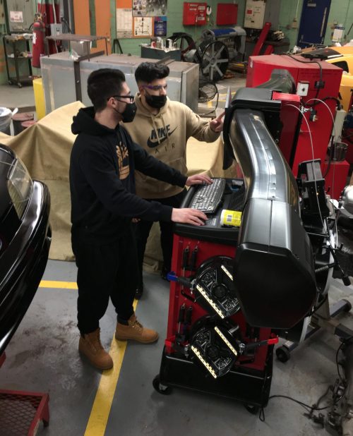 Two Fordson High School students work on new auto tech equipment on Jan. 5, 2022.