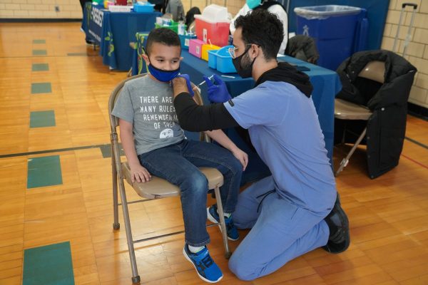 A boy receives his COVD vaccination at Nowlin Elementary on Thursday, Jan., 27, 2022.