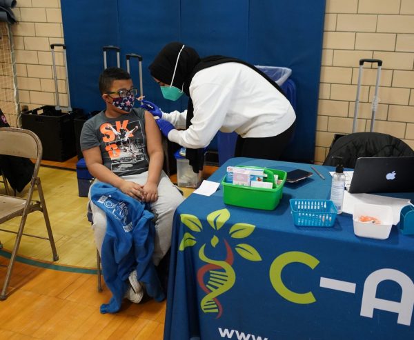 A student gets a shot during a COVID vaccine clinic at Nowlin Elementary in January 2022.