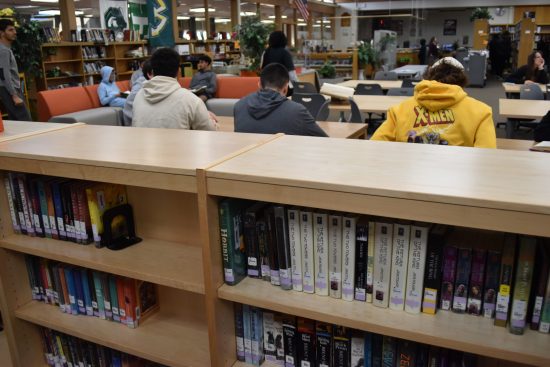 Students sit around the Dearborn High library during a class visit in October 2022.