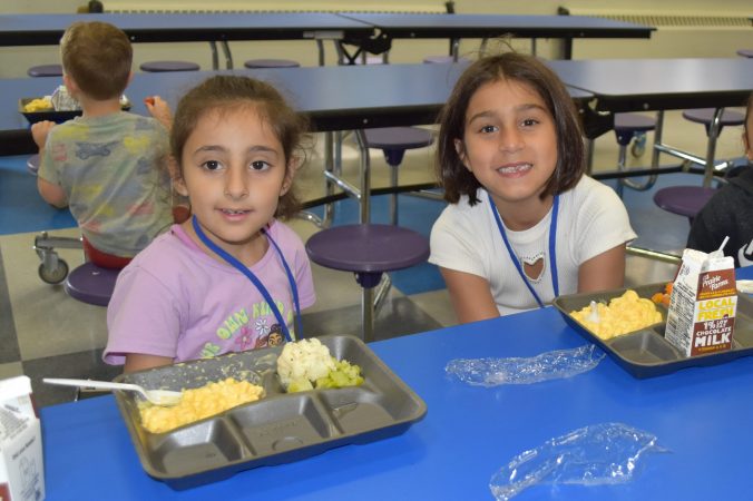 Two students eating a school lunch